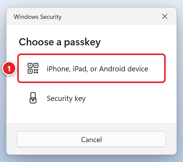 A Windows Security box titled Choose a passkey, with two choices: iPhone, iPad, or Android device, which is marked 1, and Security key. A Cancel button is at the bottom.