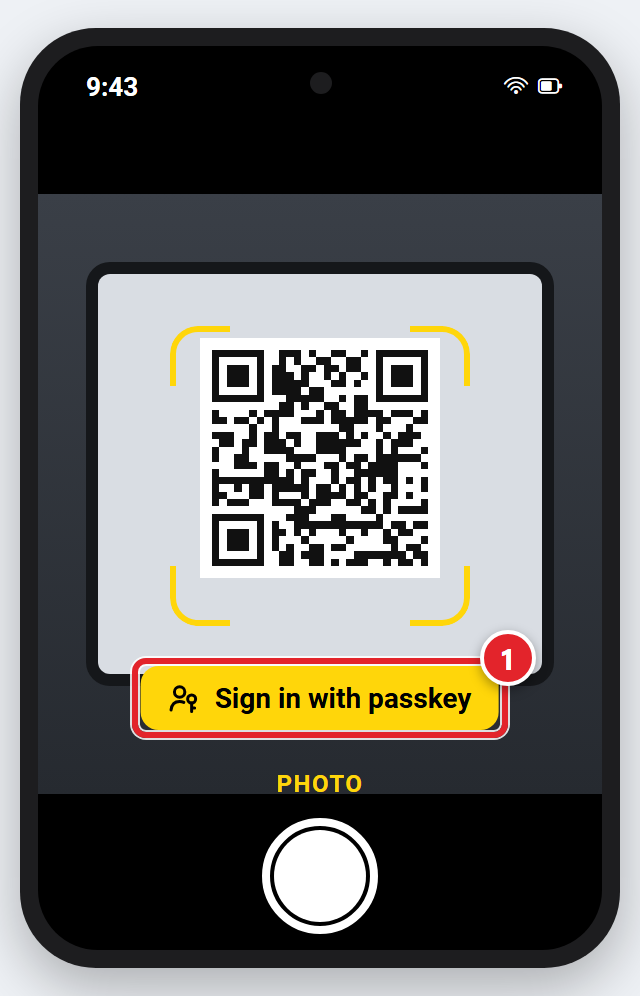 An iPhone with the Camera app pointed at the QR code on a computer screen. A yellow button below the code says Sign in with passkey and is marked 1.